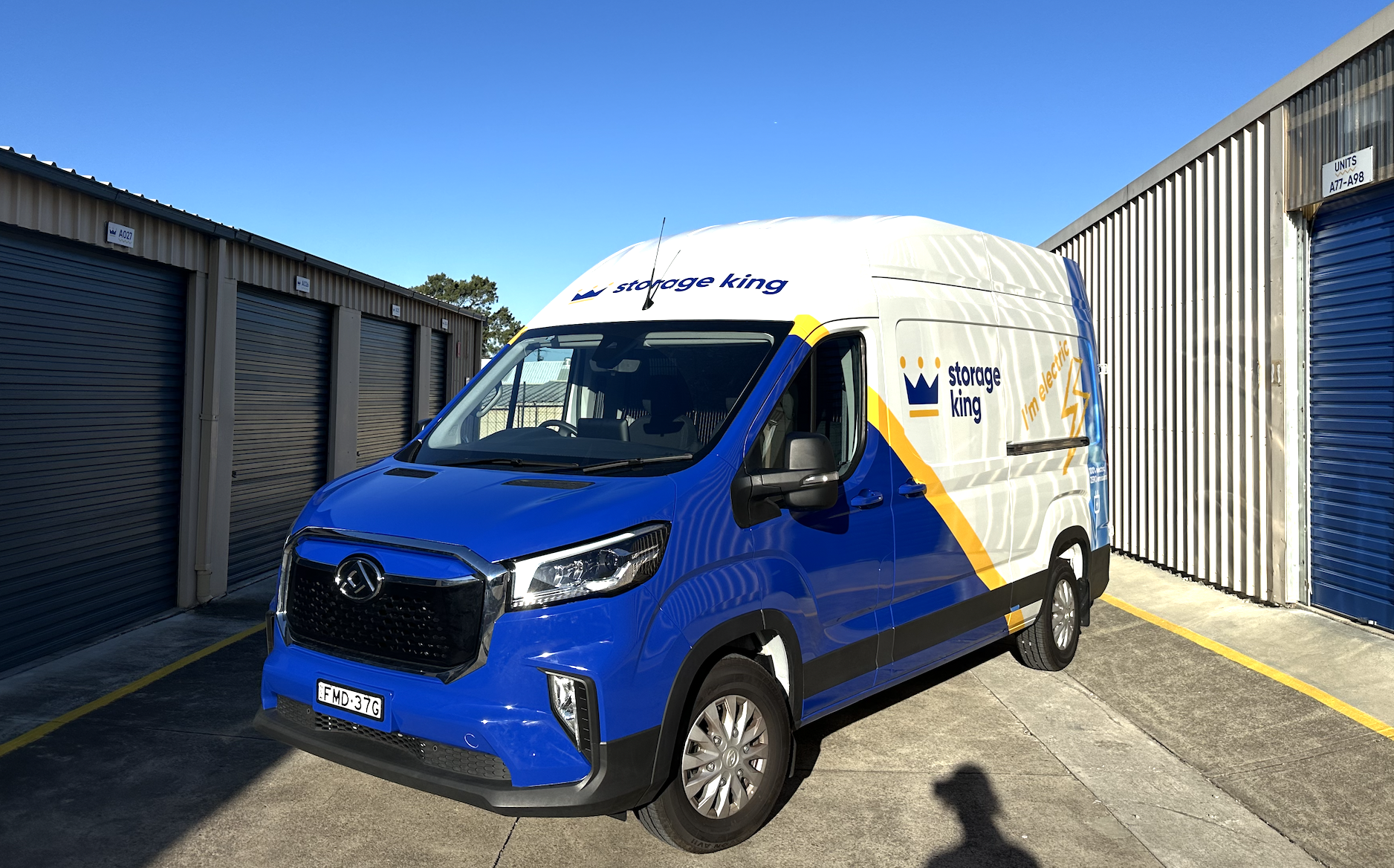 Front-side view of Storage King electric delivery van parked at storage facility